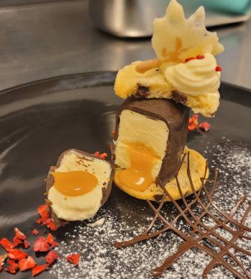 Weisse Schokoladenmousse-Kugel mit Salzkaramellkern und Cookies